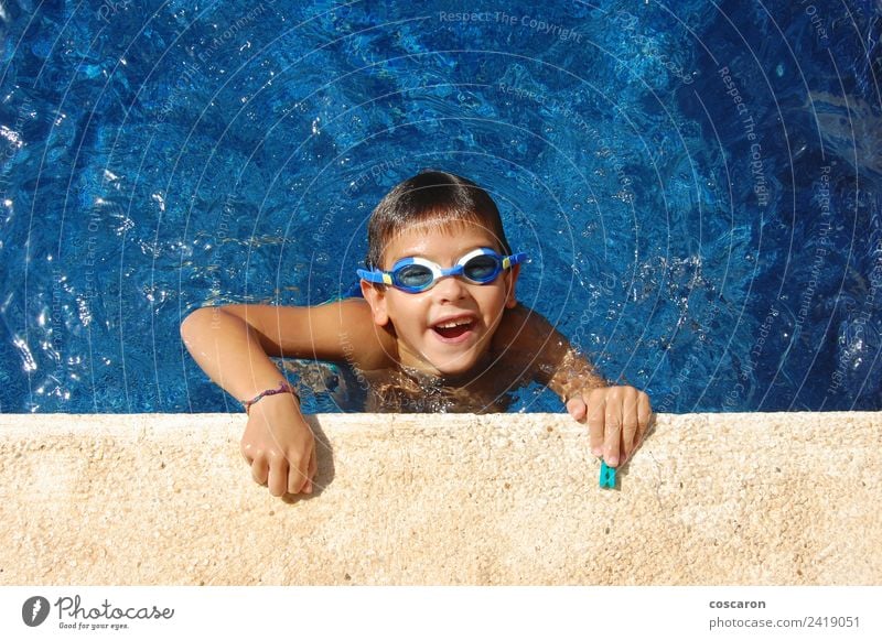 Boy with glasses in a swimming pool Joy Happy Beautiful Face Relaxation Swimming pool Leisure and hobbies Playing Vacation & Travel Summer Sun Child Infancy