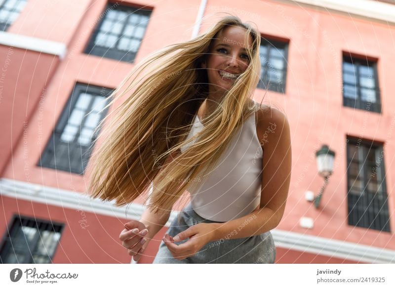 Happy young woman with moving hair in urban background Lifestyle Elegant Style Beautiful Hair and hairstyles Summer Human being Feminine Young woman