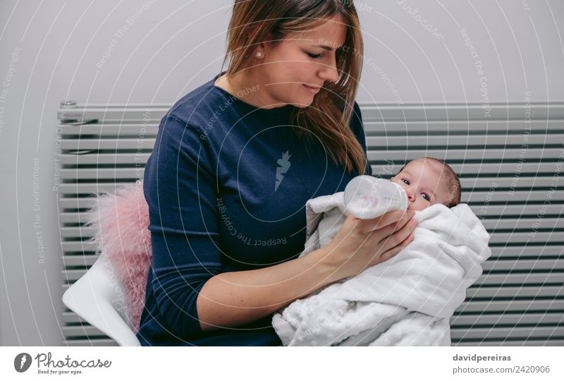 Mother giving bottle to her newborn Eating Bottle Lifestyle Happy Beautiful Chair Bedroom Child Human being Baby Woman Adults Family & Relations Infancy Hand