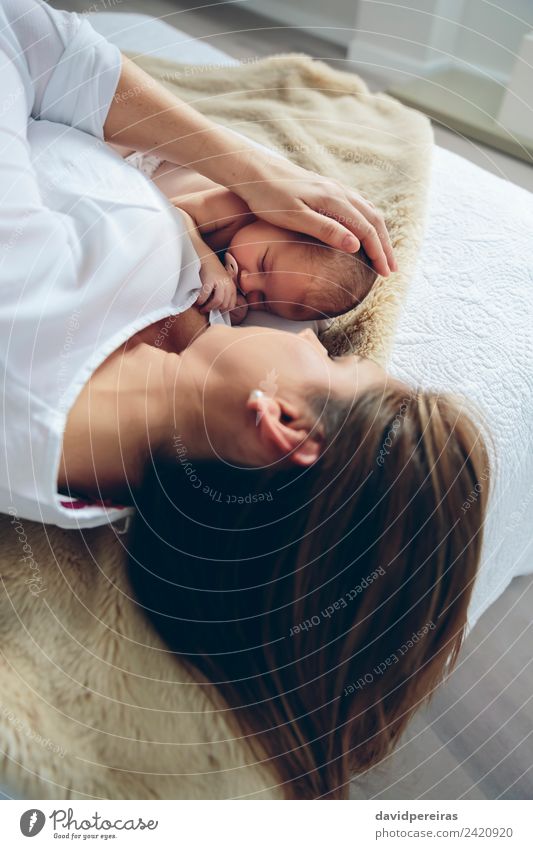 Mother hugging newborn lying on bed Lifestyle Elegant Bedroom Child Human being Baby Woman Adults Family & Relations Infancy Love Embrace Authentic Small Cute