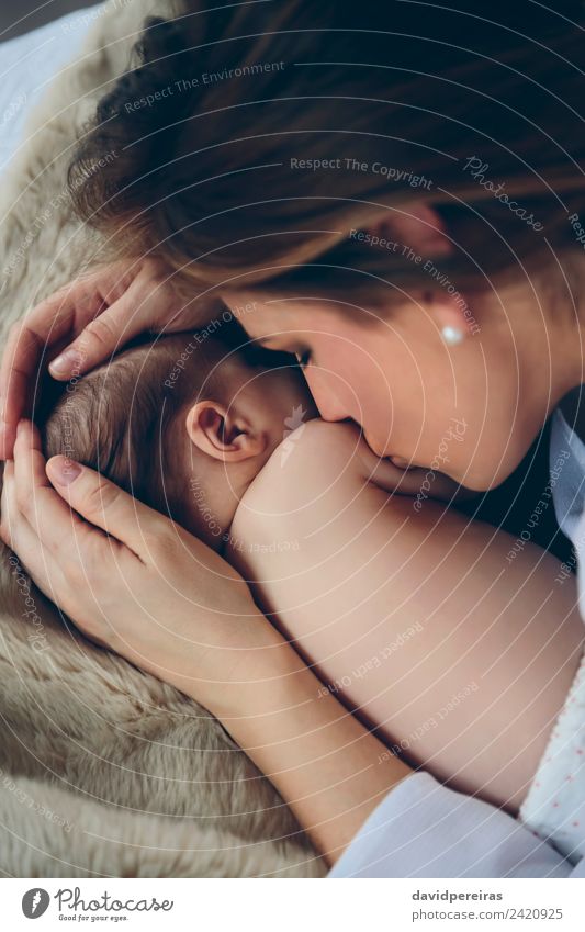 Mother kissing newborn lying on bed Lifestyle Elegant Beautiful Bedroom Child Human being Baby Woman Adults Family & Relations Infancy Kissing Love Embrace