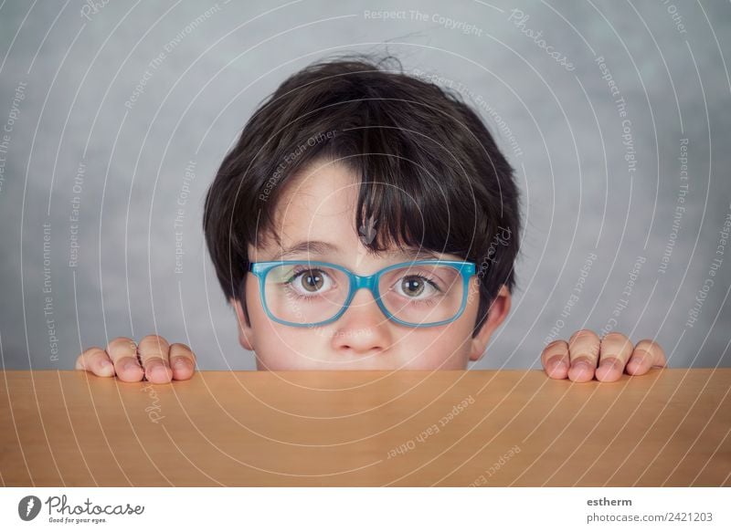 boy with glasses on a wooden table Lifestyle Education Human being Masculine Child Toddler Boy (child) Infancy 1 8 - 13 years Eyeglasses Observe Think Fitness