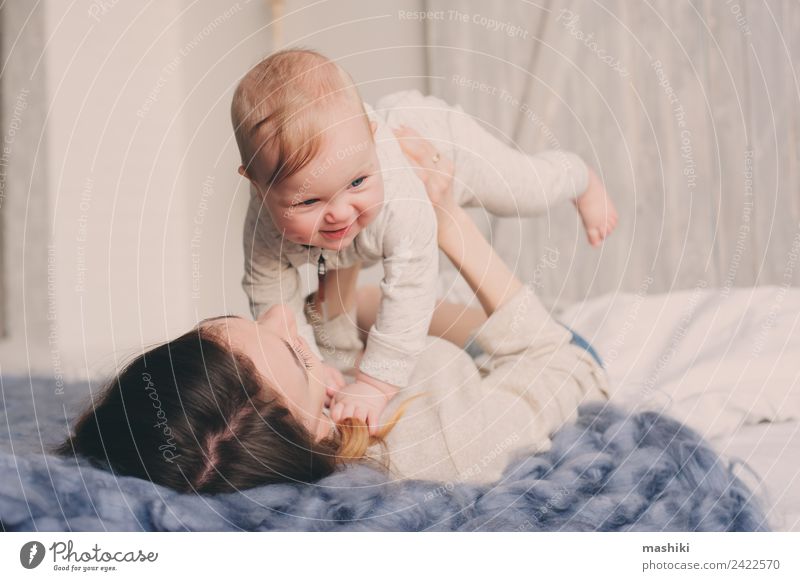 happy mother and baby playing at home in bedroom Lifestyle Joy Playing Bedroom Baby Parents Adults Mother Family & Relations Infancy Love Embrace Happiness