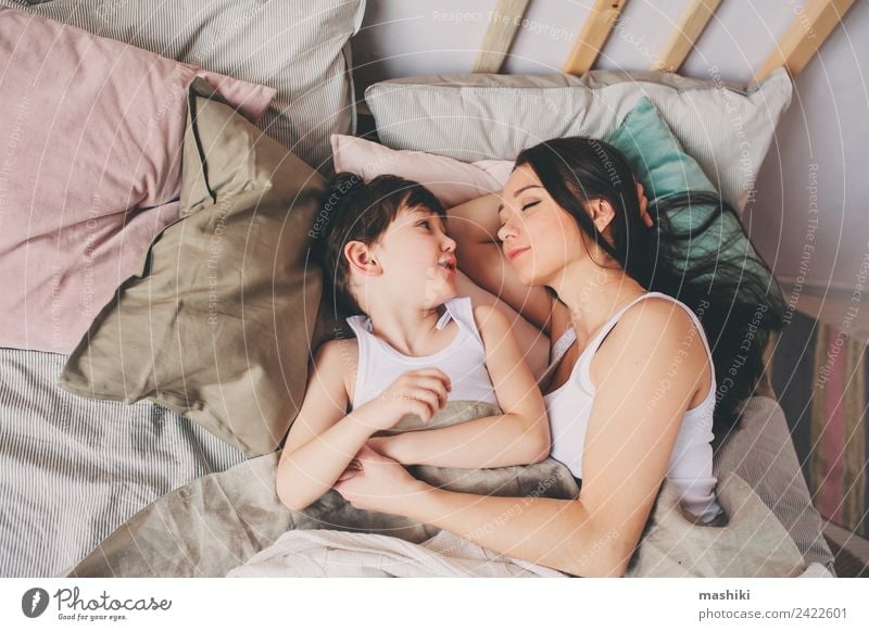 mother and child son sleeping together in bed Lifestyle Joy Relaxation Bedroom Child Toddler Boy (child) Parents Adults Mother Family & Relations Smiling Love
