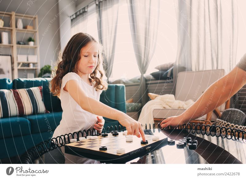 child girl playing checkers with her dad at home Lifestyle Leisure and hobbies Playing Chess Child Parents Adults Father Family & Relations Infancy Toys Think