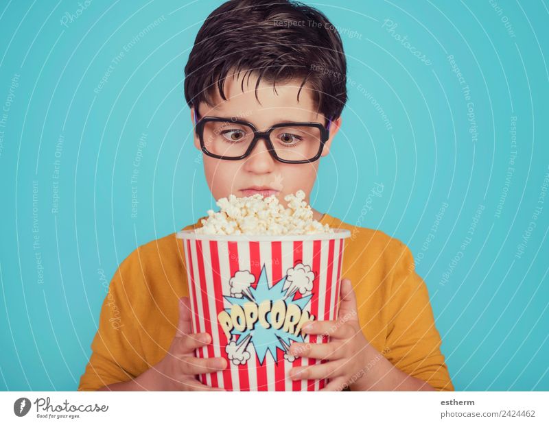 little boy child with popcorn on blue background Food Nutrition Eating Fast food Lifestyle Leisure and hobbies Human being Masculine Child Toddler Boy (child)