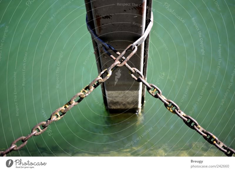 Post in water with a crossed chain Ocean Island Water Summer Beautiful weather Coast Lakeside River bank Bay Jetty Harbour Pole Chain Metal Esthetic Simple Firm