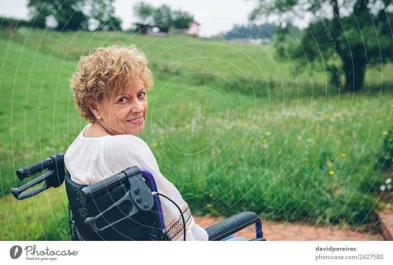 Smiling senior woman in wheelchair Happy Health care Relaxation Garden Retirement Human being Woman Adults Grandmother Nature Plant Tree Grass Old Sit Authentic
