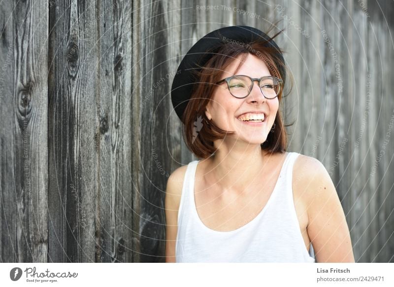 untroubled Feminine Young woman Youth (Young adults) 1 Human being 18 - 30 years Adults Wall (barrier) Wall (building) Eyeglasses Hat Brunette Short-haired Wood