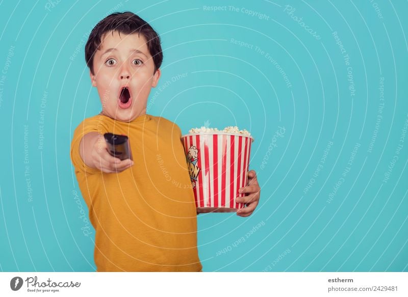 surprised boy with popcorn and television remote control on blue background Food Nutrition Fast food Lifestyle Joy Leisure and hobbies Human being Masculine
