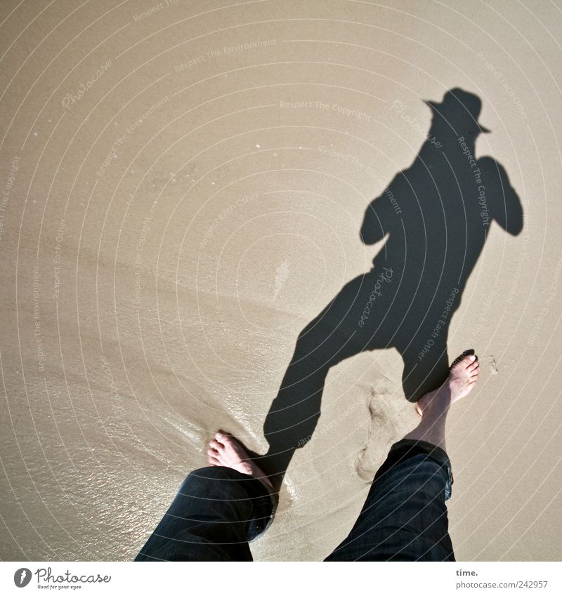 shadow clipper Beach Masculine Man Adults Legs Feet Sand Water Pants Hat Wet Barefoot Damp Colour photo Subdued colour Exterior shot Copy Space left