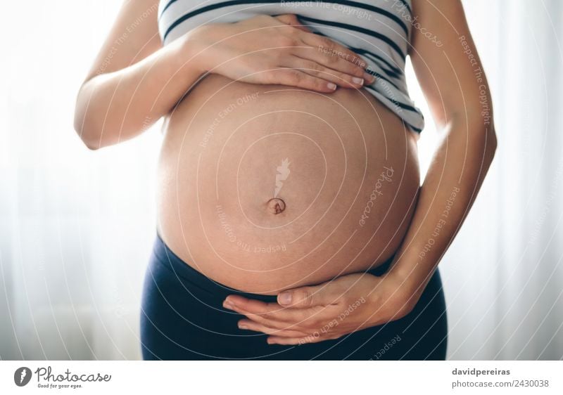 Pregnant woman holding her tummy Lifestyle Beautiful Human being Baby Woman Adults Mother Hand Love Wait Authentic Naked Serene Expectation Unrecognizable Bare