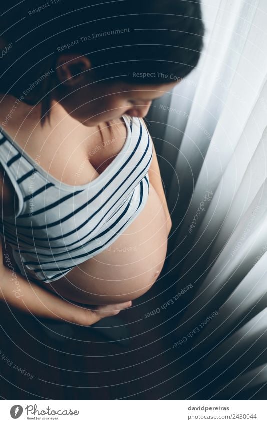 Pregnant woman looking her belly Lifestyle Beautiful Parenting Human being Baby Woman Adults Mother Hand Think Love Wait Authentic Naked Expectation Future Bare
