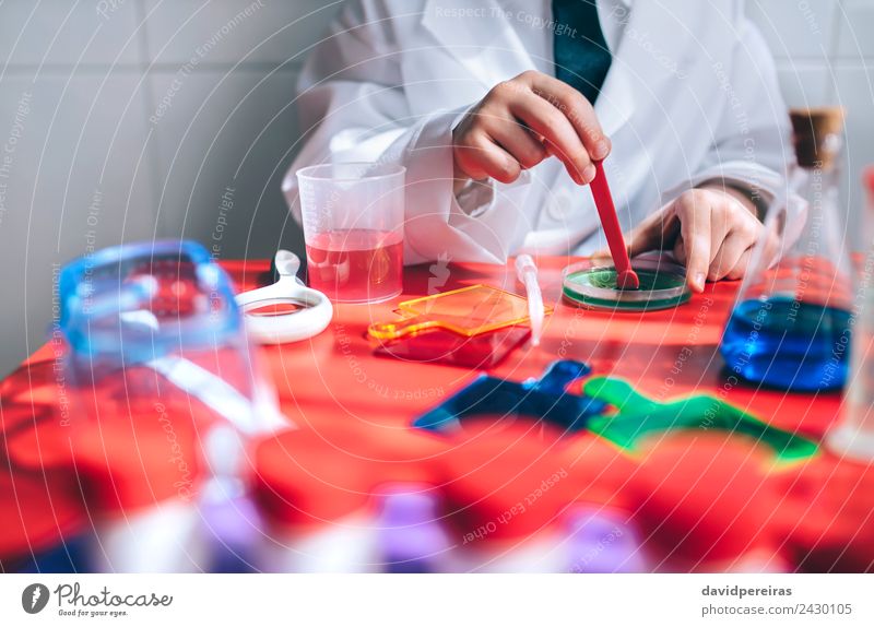 Boy hands playing to be chemist with colorful liquids Bottle Spoon Playing Flat (apartment) Table Science & Research Child Classroom Laboratory Human being