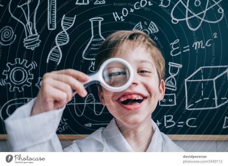 Happy kid looking at camera through magnifying glass Joy Playing Flat (apartment) Science & Research Child School Classroom Blackboard Laboratory Human being