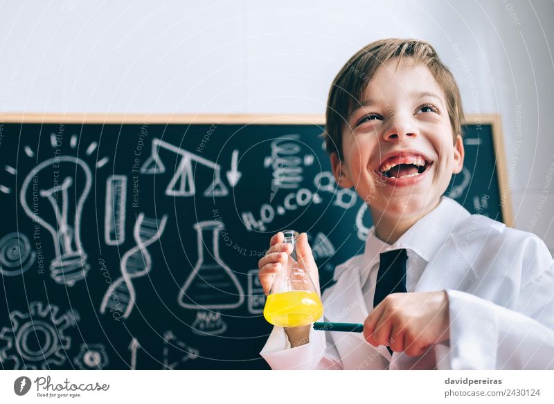 Happy kig laughing and showing liquid in flask Playing Flat (apartment) Science & Research Child Classroom Blackboard Laboratory Human being Boy (child) Infancy