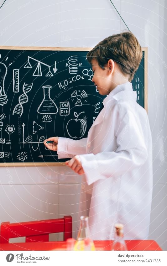 Kid showing drawings on chalkboard with marker Happy Playing Flat (apartment) Science & Research Child Classroom Blackboard Laboratory To talk Human being