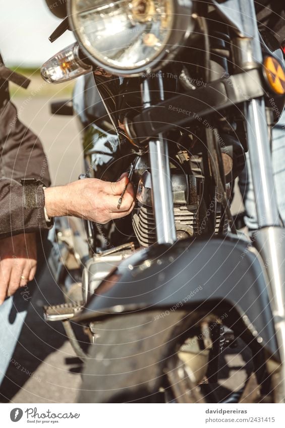 Senior man repairing damaged motorcycle engine Lifestyle Vacation & Travel Trip Adventure Human being Man Adults Hand Transport Street Vehicle Motorcycle Metal