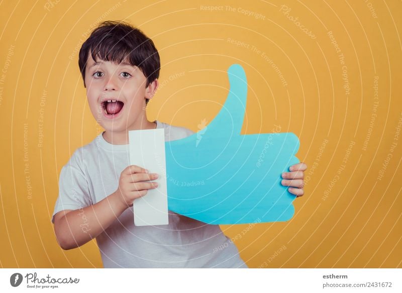 boy with a big like on yellow background Lifestyle Joy Human being Masculine Child Toddler Boy (child) Infancy 1 8 - 13 years Sign Signs and labeling To hold on