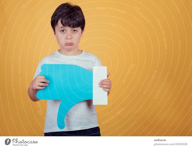 sad boy with a big dislike on yellow background Lifestyle Human being Masculine Child Toddler Boy (child) Infancy 1 8 - 13 years Sign Signs and labeling