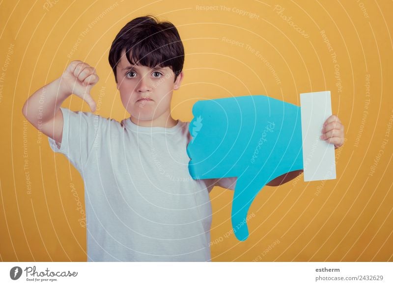 sad boy with a big dislike on yellow background Lifestyle Human being Masculine Child Toddler Boy (child) Infancy 1 8 - 13 years Sign Signs and labeling To talk