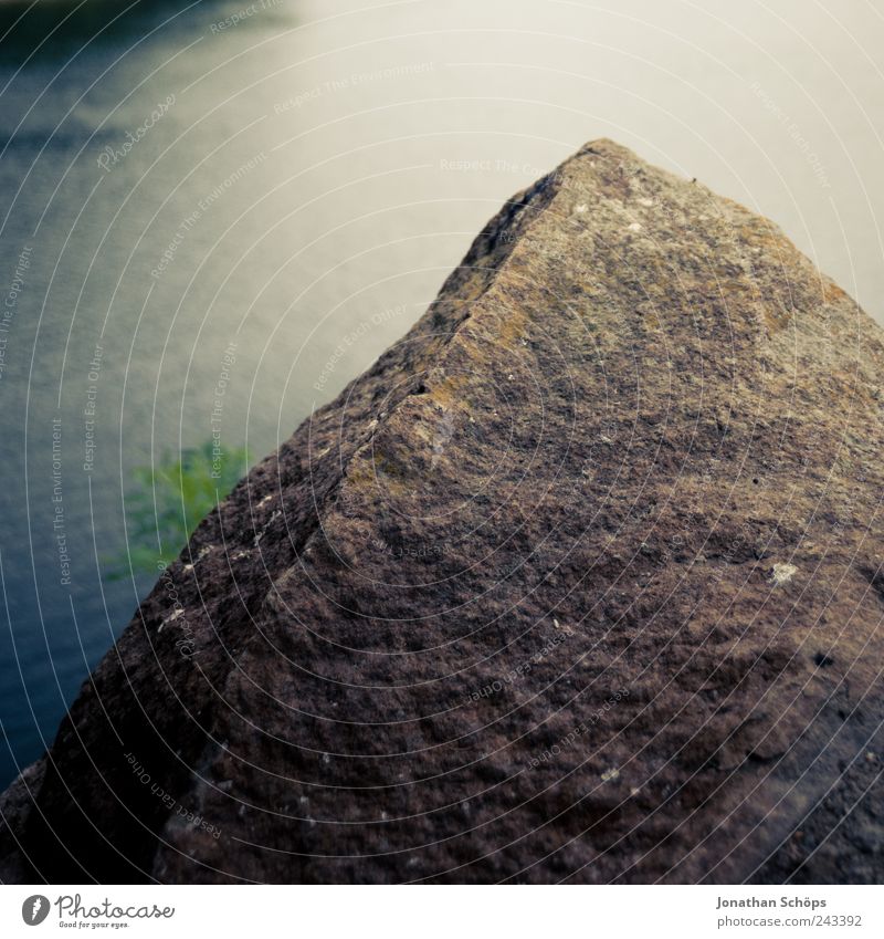 The rock in front of the water Environment Nature Elements Water Coast Lakeside River bank Blue Brown Green Stone Stony Reservoir Square Looking