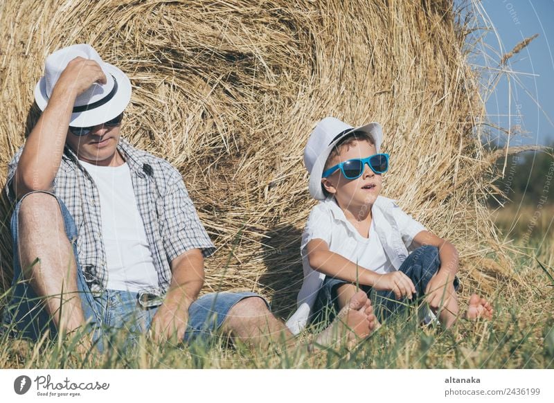 Father and son sitting in the park Lifestyle Joy Happy Leisure and hobbies Playing Vacation & Travel Freedom Summer Sun Sports Child Human being Boy (child) Man