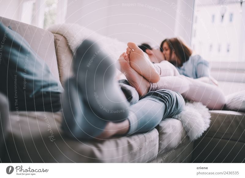Young adult couple kissing each other on couch Lifestyle Happy Beautiful Leisure and hobbies House (Residential Structure) Sofa Woman Adults Man Couple Kissing