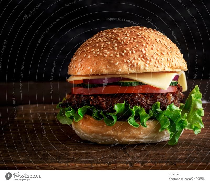 fresh homemade burger Meat Cheese Vegetable Bread Roll Lunch Fast food Table Restaurant Wood Eating Fresh Large Delicious Green Red Black Hamburger Cheeseburger