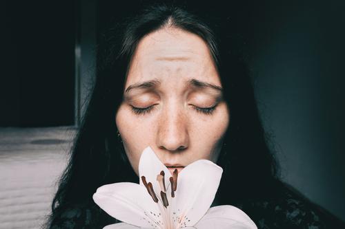 a girl with a white lily and eyes closed worried Lifestyle Beautiful Face Relaxation Calm Human being Feminine Young woman Youth (Young adults) Woman Adults 1