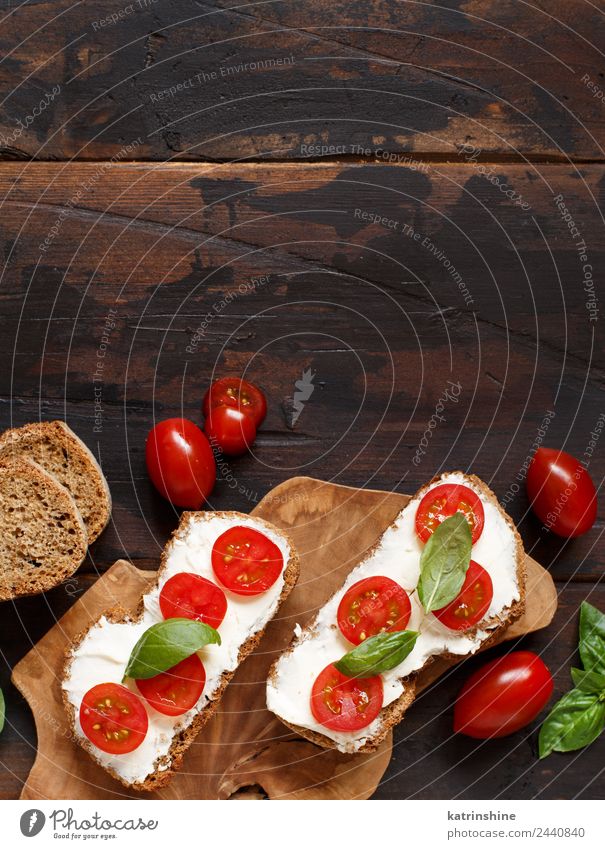 Bruschetta with cream cheese, cherry tomatoes and basil Cheese Bread Eating Breakfast Lunch Fresh Green Red appetizer Baguette board bruschetta cooking Dairy