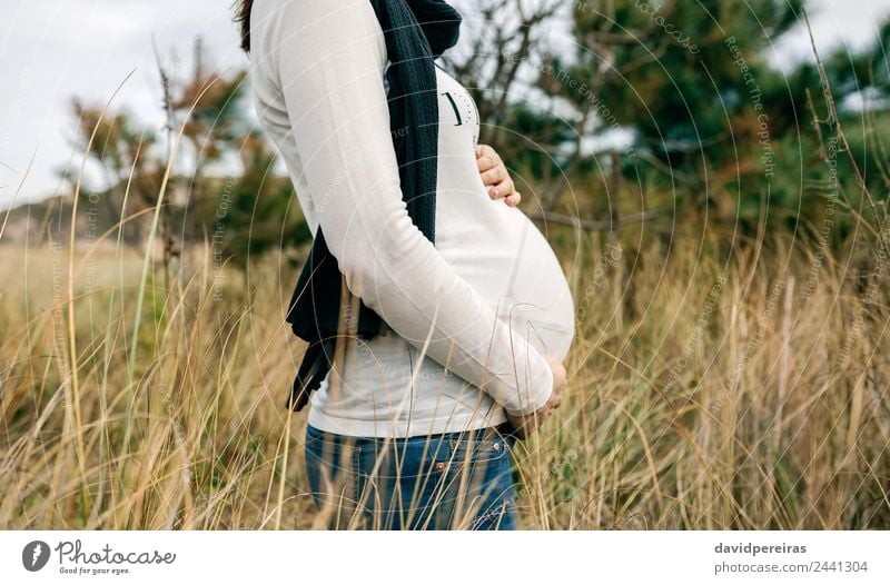 Pregnant woman caressing her tummy Lifestyle Joy Happy Leisure and hobbies Human being Baby Woman Adults Mother Family & Relations Nature Landscape Grass Meadow