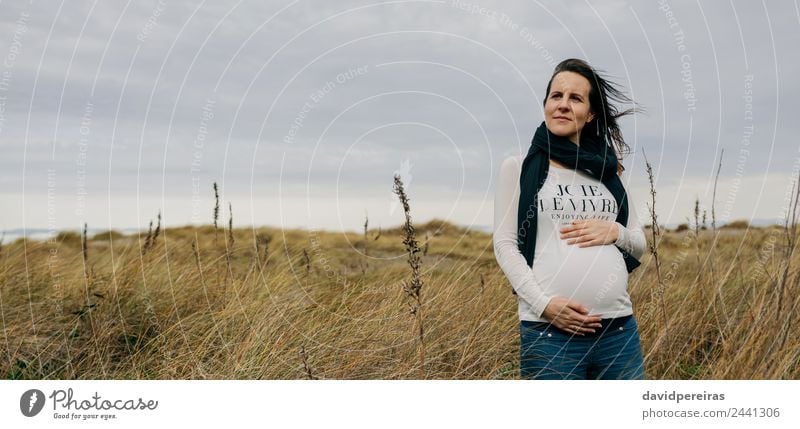 Pregnant woman caressing her tummy Lifestyle Joy Happy Human being Baby Woman Adults Mother Hand Nature Landscape Grass Meadow Scarf Touch Smiling Wait