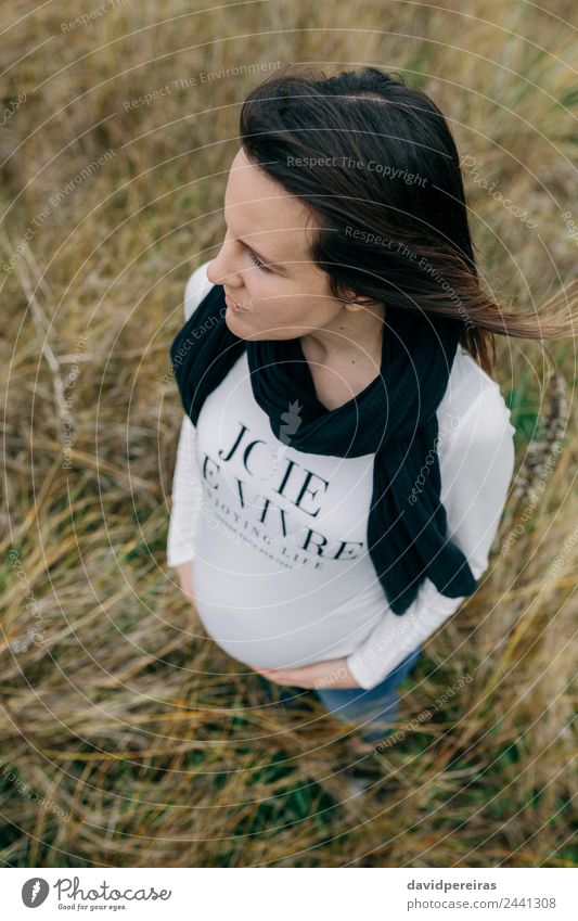 Pregnant woman holding her tummy Lifestyle Happy Beautiful Human being Baby Woman Adults Mother Hand Nature Landscape Grass Meadow Aircraft Scarf Touch