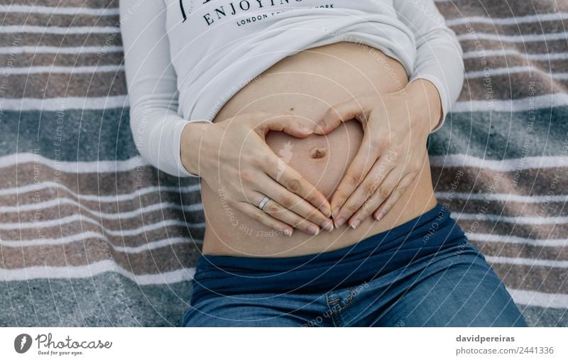 Pregnant belly lying on a blanket Lifestyle Relaxation Human being Baby Woman Adults Parents Mother Hand Aircraft Ring Touch Authentic Naked Expectation