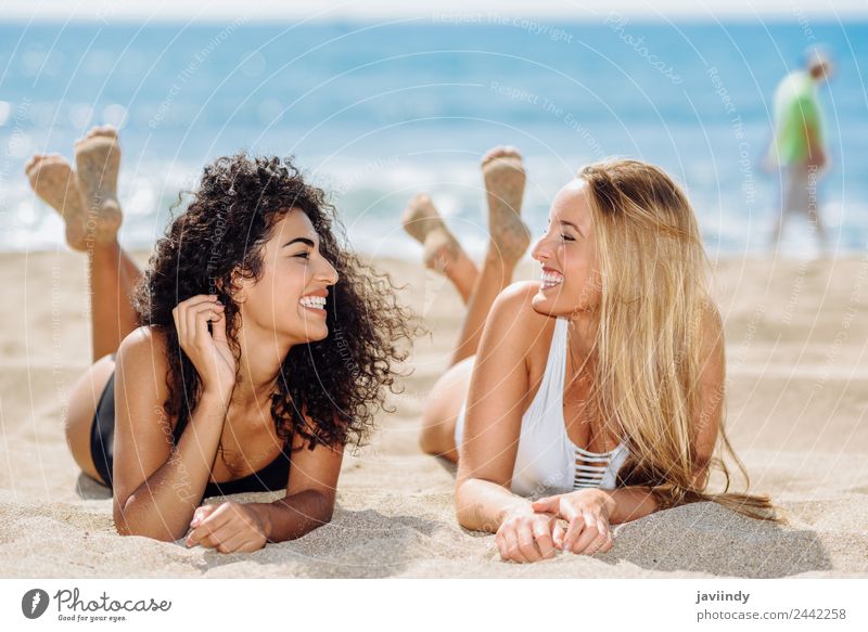 Two women lying on the sand on the beach Lifestyle Joy Hair and hairstyles Vacation & Travel Summer Beach Feminine Young woman Youth (Young adults) Woman Adults