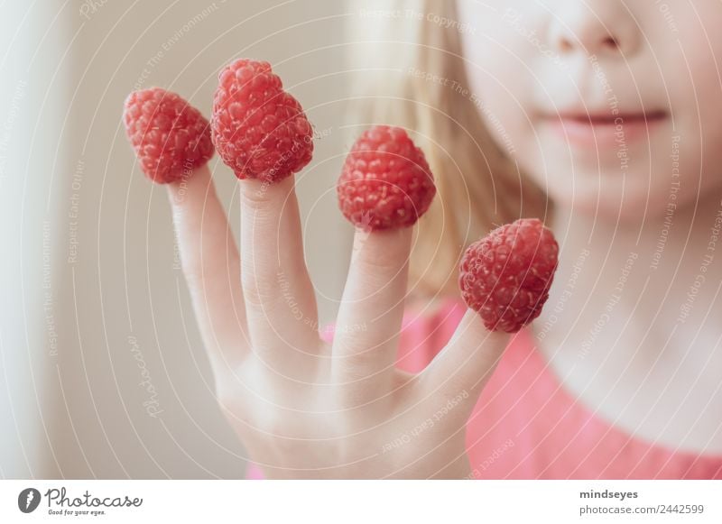 Blonde girl put raspberries on her fingers Feminine Infancy by hand 1 Human being 3 - 8 years Child Berries Eating To enjoy smile Playing Happiness Fresh