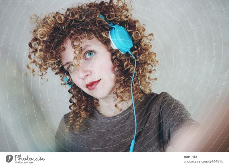 Young blonde woman listening to music with her headphones Lifestyle Style Beautiful Hair and hairstyles Leisure and hobbies Headset Headphones Technology