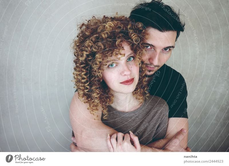 Studio portrait of a young couple hugging Lifestyle Elegant Style Joy Beautiful Human being Masculine Feminine Young woman Youth (Young adults) Young man