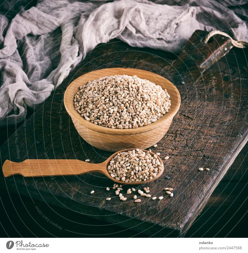 grain of wheat in a wooden bowl Bread Vegetarian diet Plate Spoon Table Wood Above Brown Yellow White Wheat background whole Cereal food healthy Rye seed