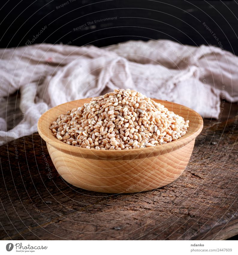 wheat grain in a wooden bowl Bread Vegetarian diet Plate Table Wood Eating Brown Yellow White Wheat background whole Cereal food healthy Rye seed Organic Raw