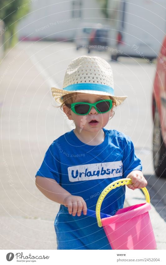 A toddler with straw has wearing sunglasses and sand toy in hand Beach Human being Baby Family & Relations Hand To hold on Playing beach chair boy caucasian