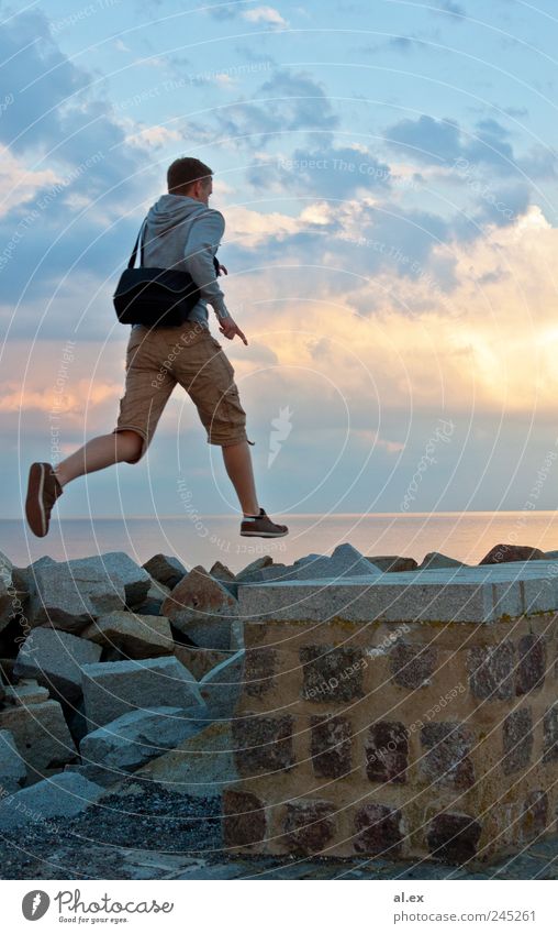 overcoming Masculine Adults 1 Human being Beautiful weather Rock Baltic Sea Wall (barrier) Wall (building) Stone Concrete Water Jump Athletic Infinity