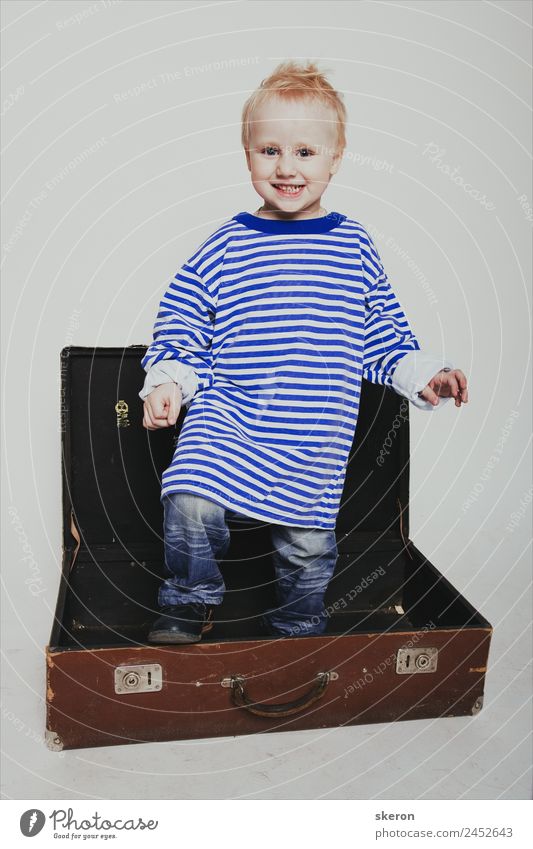 smiling boy in a long t-shirt in a suitcase Human being Baby Boy (child) Infancy Skin Head Hair and hairstyles Face Eyes Ear Nose Mouth 1 1 - 3 years Toddler