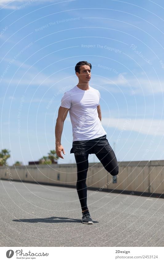 Young man stretching in the city after jogging Lifestyle Body Wellness Summer Sports Jogging Masculine Youth (Young adults) Man Adults 1 Human being