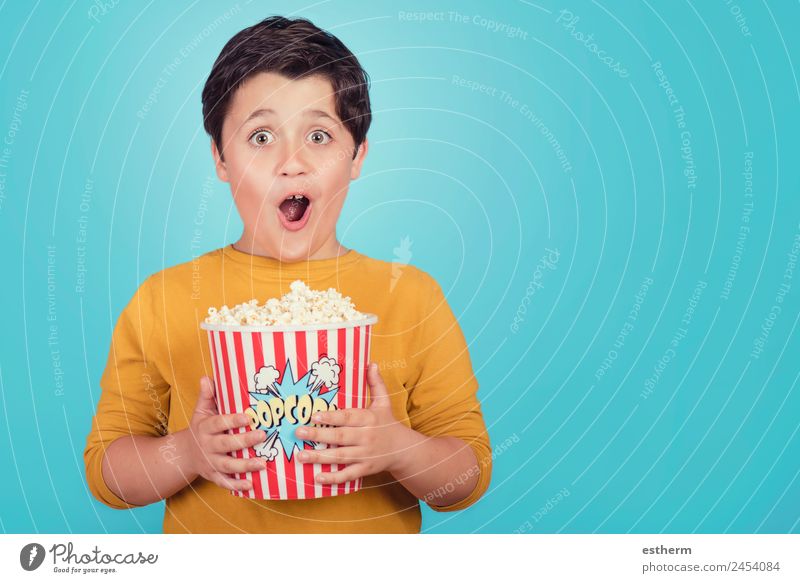 happy boy with popcorn on blue background Food Lifestyle Joy Leisure and hobbies Entertainment Human being Masculine Child Toddler Boy (child) Infancy 1