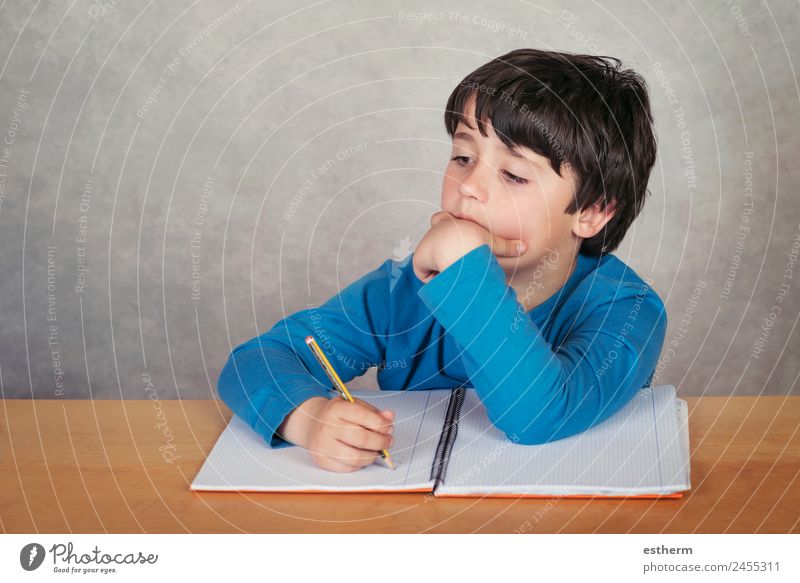 sad and pensive boy with a book on gray background Lifestyle Reading Child School Study Human being Masculine Toddler Boy (child) Infancy 1 8 - 13 years Culture