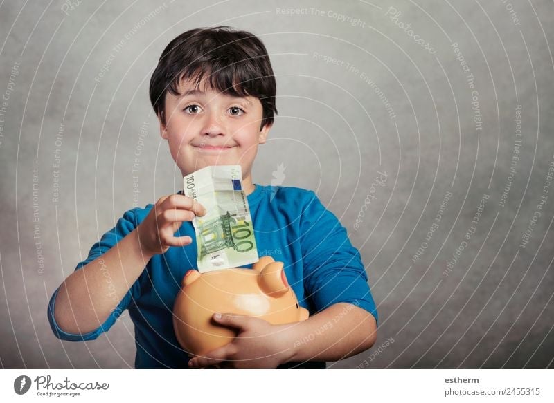 Happy child saving money in a piggy bank Lifestyle Joy Money Save Child Work and employment Economy Financial Industry Financial institution Business