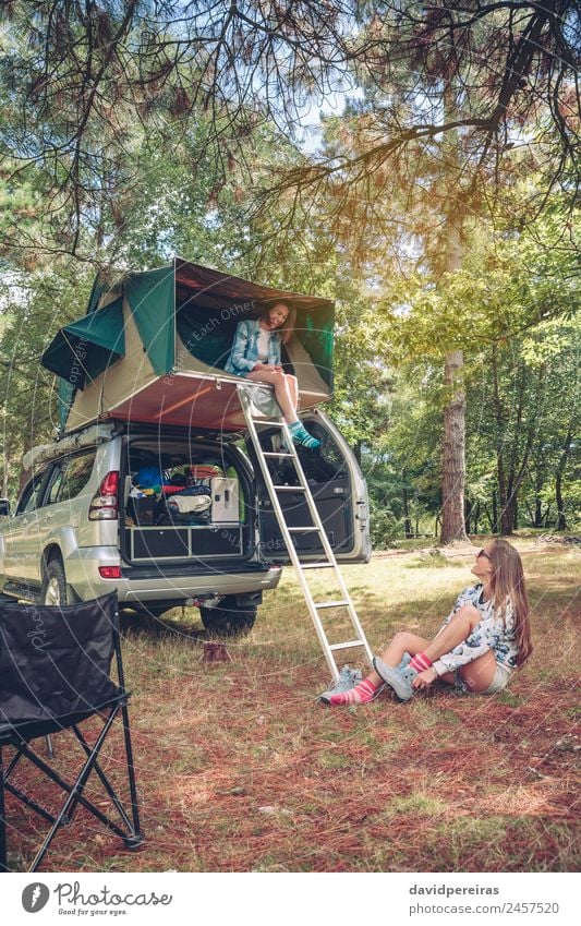 Woman in tent over car and other putting hiking boots Lifestyle Joy Happy Relaxation Leisure and hobbies Vacation & Travel Trip Adventure Camping Summer