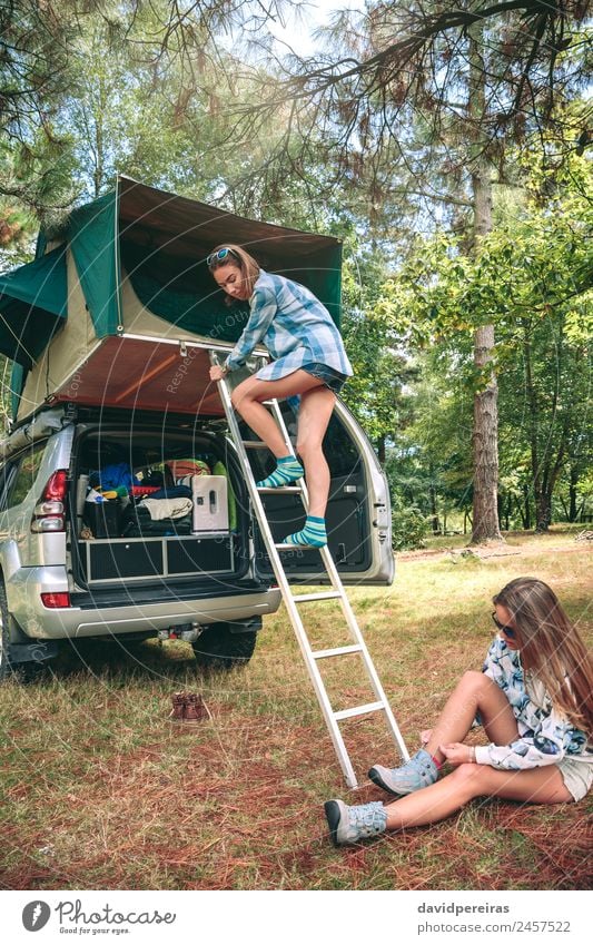Woman descending ladder form tent over car Lifestyle Joy Happy Relaxation Leisure and hobbies Vacation & Travel Trip Adventure Camping Summer Mountain Hiking